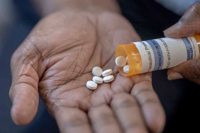 Pills being tipped into a hand