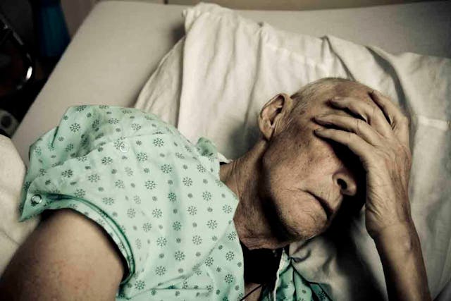 Sick man in hospital bed